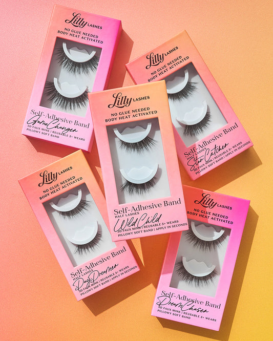 Five boxes of Lilly Lashes on a gradient background